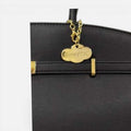 Bolso Diábolo negro de piel vacuno premium con diseño estructurado y herrajes dorados elegante y versátil.