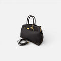 Bolso Diábolo negro de piel vacuno premium con diseño estructurado y herrajes dorados.